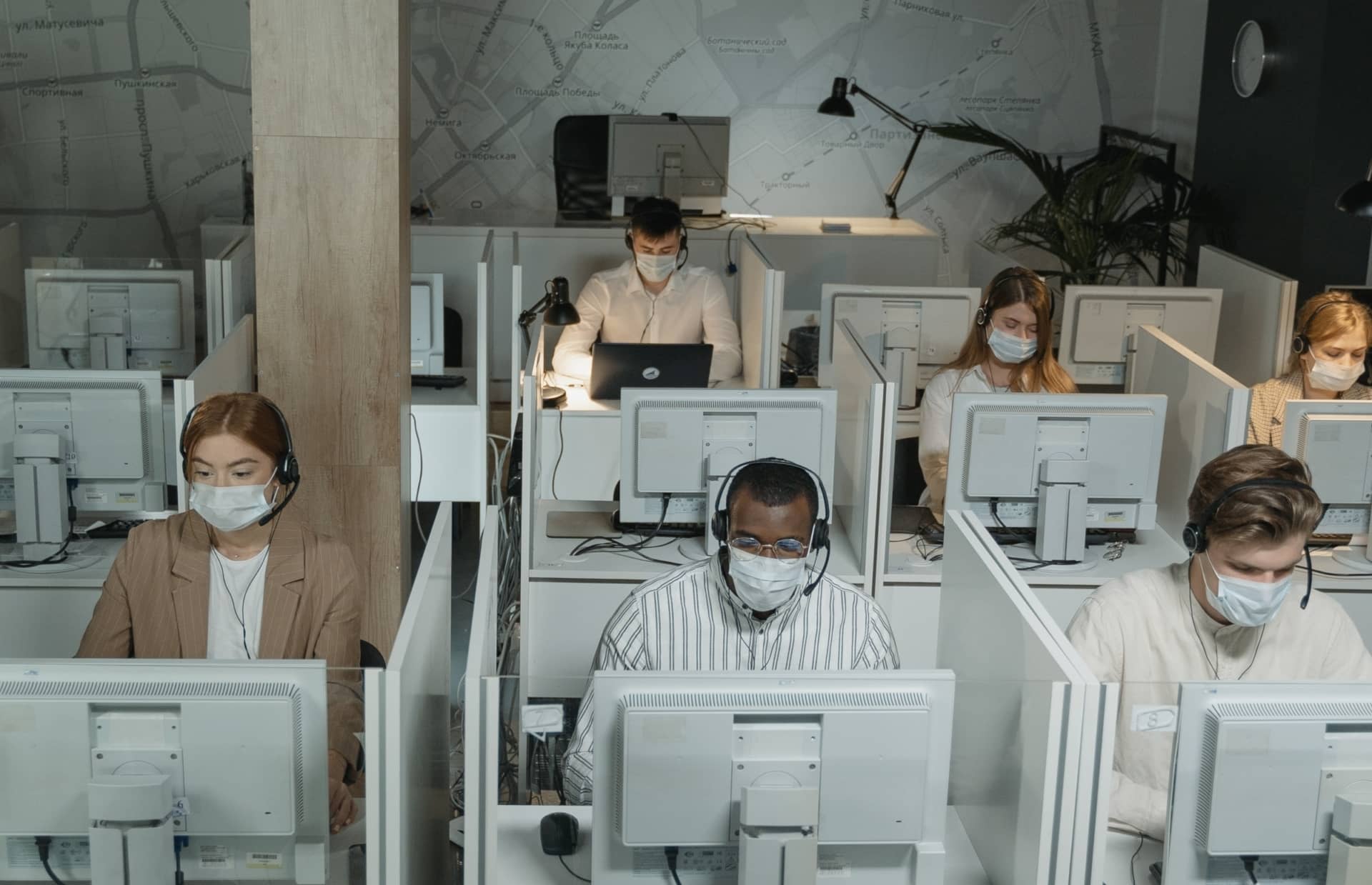 cubicles with people wearing masks