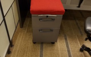 file cabinet with red cushion