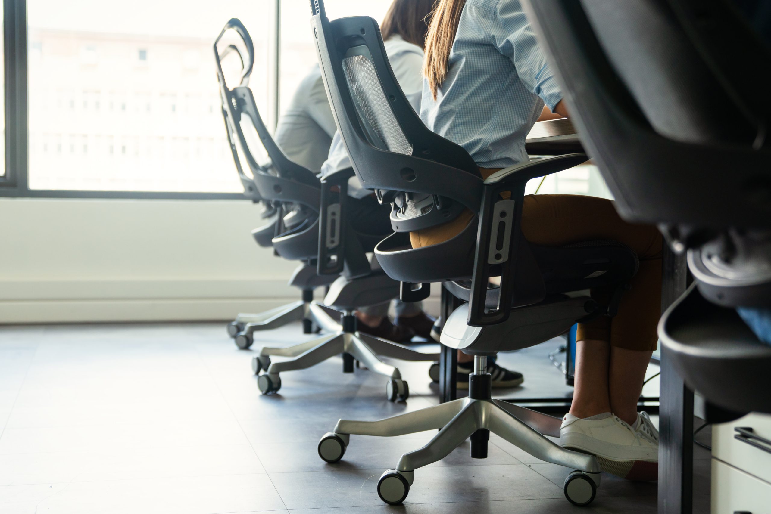 close up of people sitting in office chairs